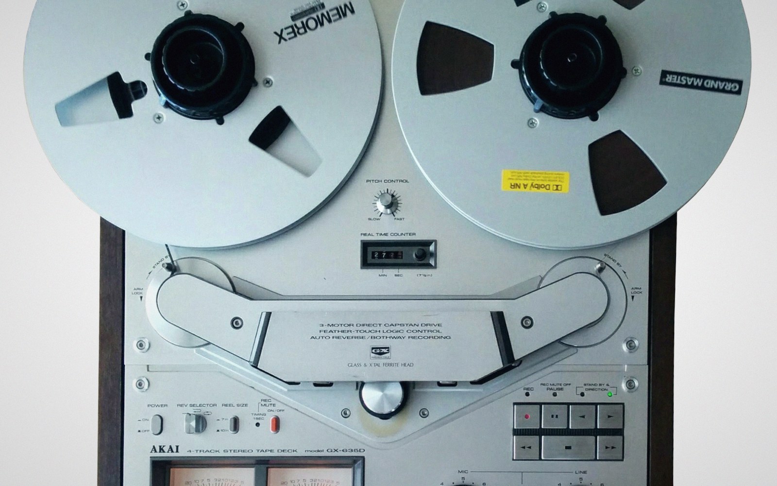 An Akai reel-to-reel tape deck with two Memorex tape reels loaded