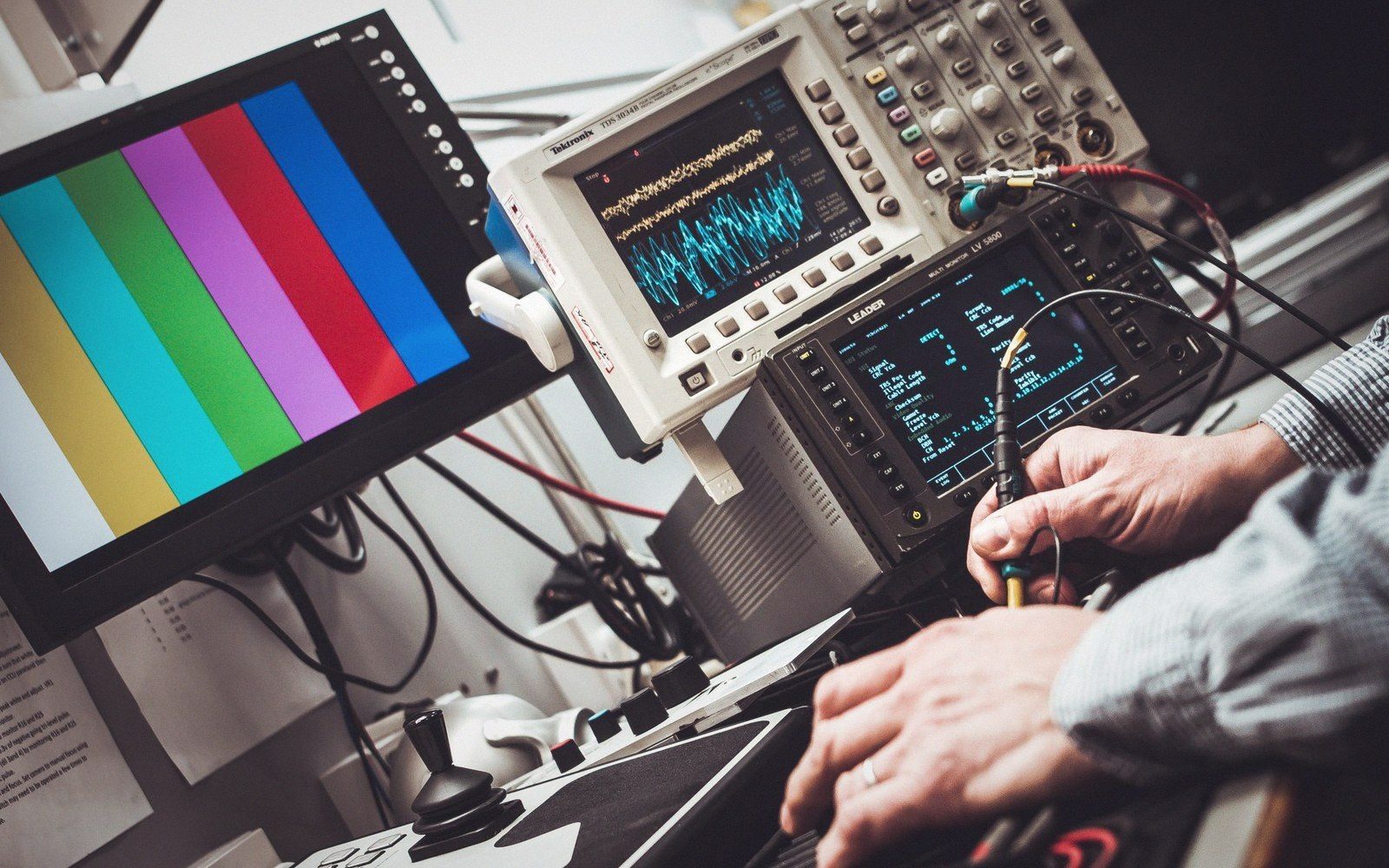 An oscilloscope showing a single waveform on a laboratory bench